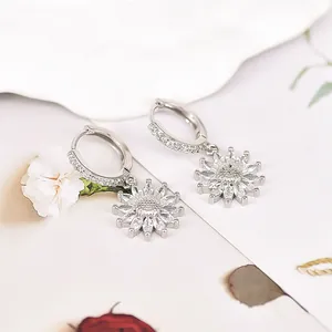 Detail of silver sunflower drop earrings featuring marquise-cut cubic zirconia petals