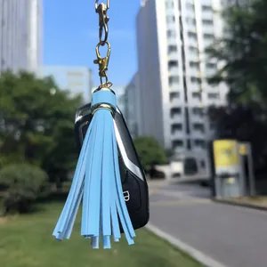 Light blue leather tassel charm with golden lobster clasp attached to a car key