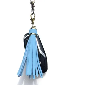 Light blue leather tassel charm with golden lobster clasp attached to a car key