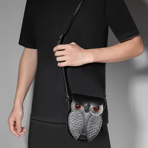 Détail du sac bandoulière en forme de hibou avec écailles métalliques et grands yeux ambrés