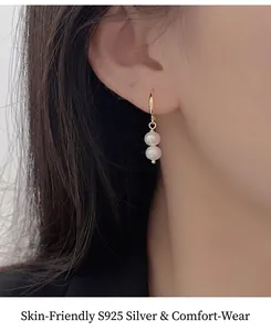 Gros plan de boucles d'oreilles double perle en argent 925 portées par un mannequin