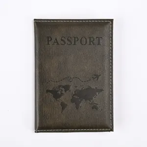 Close-up of textured dark faux leather passport cover with map design and white stitching