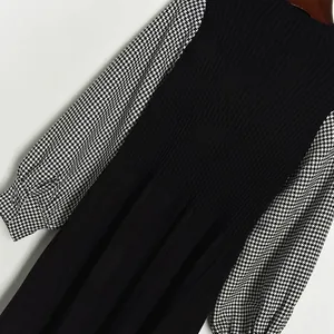 Knitted long sleeve dress with black ribbed body and houndstooth pattern contrast sleeves