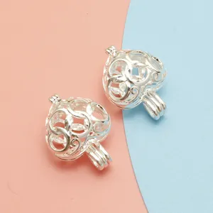 Detailed view of silver hollow heart-shaped locket pendants for DIY jewelry designs
