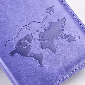 Macro shot of purple PU leather passport cover with embossed world map and white stitching