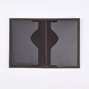 Detail view of brown PU leather passport holder showing interior pockets and white stitching