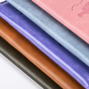 Detail of colorful PU leather passport covers with embossed world map and flight paths