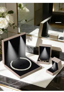 Detailed view of brushed PU jewelry box with LED light reflecting on pearl necklace