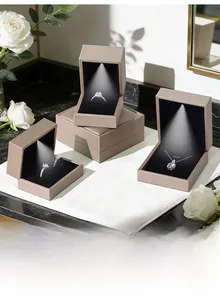 Detail view of champagne gold jewelry box with LED spotlight illuminating the black lining