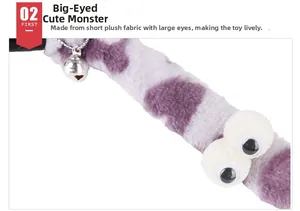 Detail of plush cat toy featuring purple spotted fabric, googly eyes and silver bell
