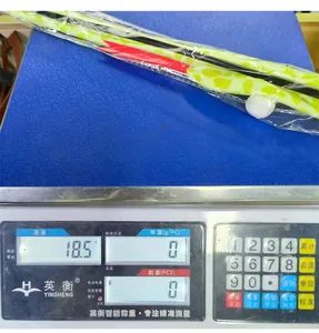 Detailed view of striped cat toy wand on weight scale showing a net weight of 18.5g