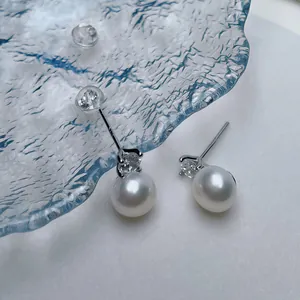 Macro detail of S925 sterling silver stamp on freshwater pearl earrings with zircon
