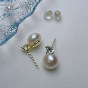 Macro shot of S925 silver pearl earrings with sparkling diamond studs and silicone backs