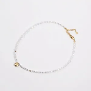 Detail of pearl necklace with gold heart pendant and lobster clasp adjustable chain