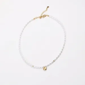 Detail of beaded pearl necklace with gold heart pendant and adjustable metal clasp