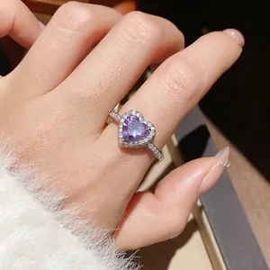 Macro detail of silver ring featuring a purple heart zircon and micro pavé accents
