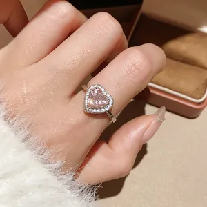 Close-up of 18k gold plated heart ring with pink zircon halo and silver band