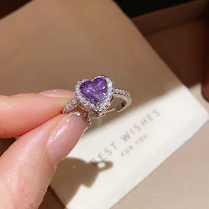 Detail of 18k gold plated silver ring with purple heart zircon and pavé crystals