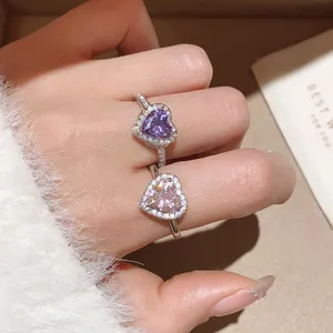 Detailed close-up of 18k gold plated heart rings with purple and pink zircon stones