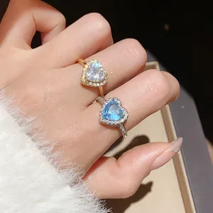 Elegant 18k gold plated heart rings with pavé zircon stones on a soft white background
