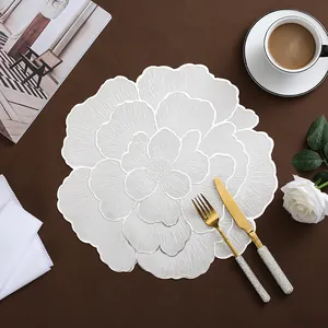 Elegant white peony floral PVC placemat with gold stamping on a dark wooden table