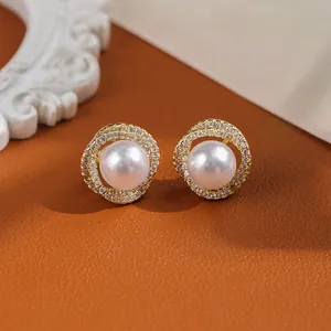 Detailed macro view of S925 silver pearl earrings with double halo pavé crystals