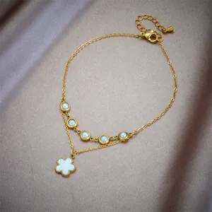 Double-layer gold stainless steel anklet featuring white pearls and a clover flower charm