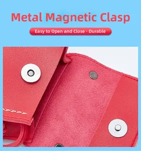 Detail of red pebbled leather mini bag featuring secure double magnetic clasp closure