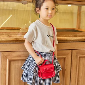Red mini crossbody bag for girls with bow decoration and contrast stitching details