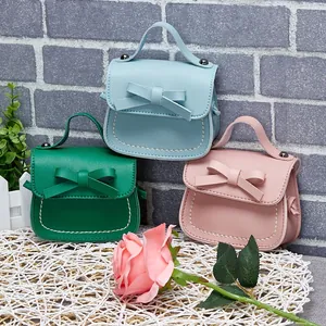 Mini girls' crossbody bags in blue, green, and pink colors with stylish bow decoration
