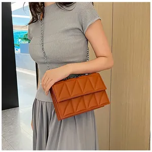 Brown quilted chain bag shown on model highlighting shoulder fit and luxury texture