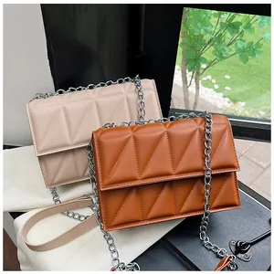 Detail of geometric quilted texture on beige and caramel leather chain shoulder bags