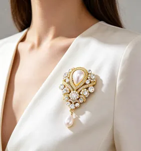 Detail einer luxuriösen Vintage Perlenbrosche mit Strass auf einem weißen Seidenrevers