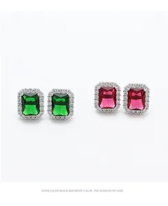 Detailed view of vintage S925 silver stud earrings with emerald and ruby cut gemstones