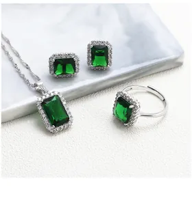Macro shot of S925 silver emerald jewelry set with rectangle green gemstones and diamonds