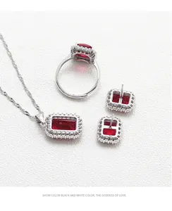 Detail of S925 silver jewelry set featuring emerald-cut red gemstones and zircon halo