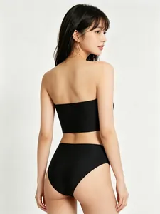 Rear view of black strapless bandeau and high-waisted briefs set on a model