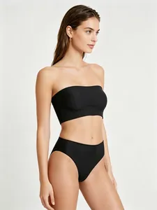Side view of seamless black strapless bandeau and high-cut panty set on model
