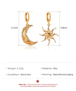 Detail view of asymmetric vintage gold celestial earrings with moon and sun charms