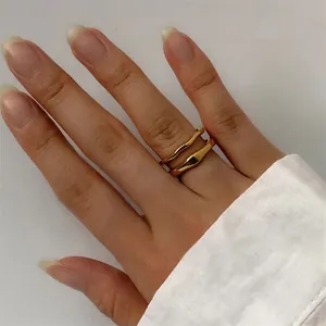 Detail shot of chunky 18K gold plated stainless steel wave ring and irregular band