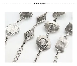 Back view of vintage metal waist chain with intricate floral patterns and silver finish