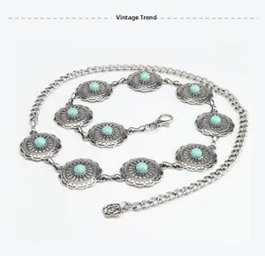 Detail of vintage metal waist chain with hollow patterns and blue turquoise stone inlay