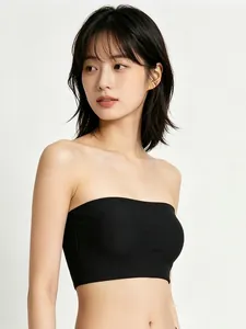 Detail of a black seamless strapless bandeau bra showing its smooth edge and fit on a model