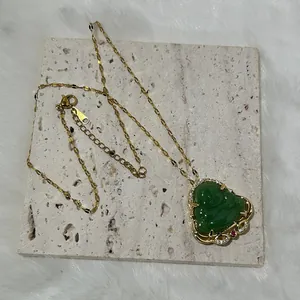 Detail of green Maitreya Buddha pendant with gold inlay and zircon on stone