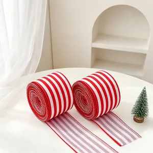 Close-up of two rolls of red and white striped ribbon for Christmas gift wrapping