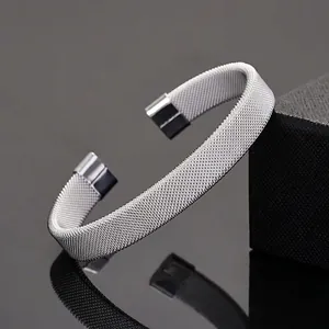Polished silver stainless steel mesh cuff bracelet with smooth square end caps on black base