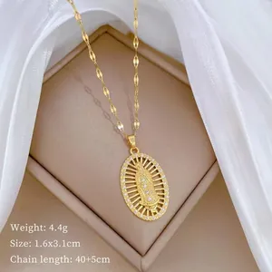 Macro shot of gold Virgin Mary oval pendant with micro-set zircons on a bamboo chain