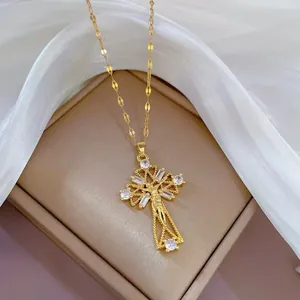 Close-up of golden cross pendant with Mary relief and sparkling zircon stones on a chain