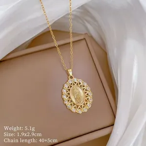 Detail of gold Virgin Mary pendant with dimensions 1.9x2.9cm and 40+5cm chain length