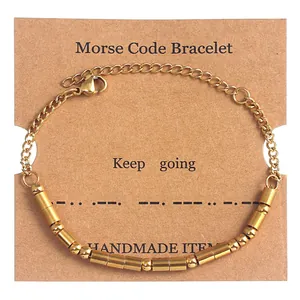 Detail of gold Morse code bead bracelet with Keep going text on handmade display card